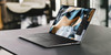 Refurbished A Dell XPS 15 9500 Touchscreen laptop on an indistinct surface, likely made of wood or metal. The laptops screen is